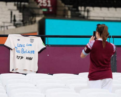 A West Ham fan takes a photo of a shirt