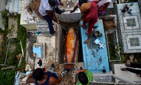 Gravediggers bury a Covid-19 victim at the municipal cemetery in Abaetetuba in Para state, Brazil on Thursday.