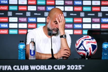 Pep Guardiola speaks to the media with a hand covering his face after Manchester City’s defeat to Al-Hilal