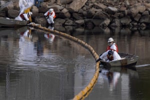 Cleanup crews work to mitigate the damage in an ecological estuary