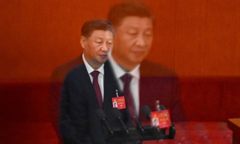 Double exposure photo showing a larger image of Xi superimposed on a smaller one. he is shown from the waist up standing against a red background