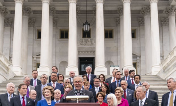 Chuck Schumer, center, speaks as other Senate Democrats listen during a news conference on the Senate steps. 