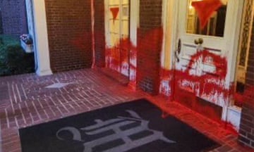 red paint splattered on door entryway and windows