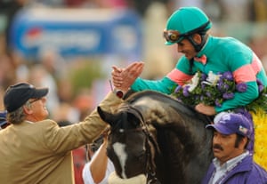 After winning the Breeders’ Cup Classic horse race, jockey Mike Smith, riding Zenyatta, and trainer John Shirreffs, left, greet each othe.