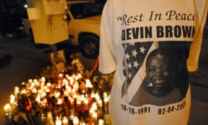 A Los Angeles resident wears a T-shirt with a picture of Devin Brown on it as she joins others at a makeshift memorial on 8 February 2005.