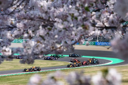 Max Verstappen leads the way as the cherry blossom provides a picturesque setting.