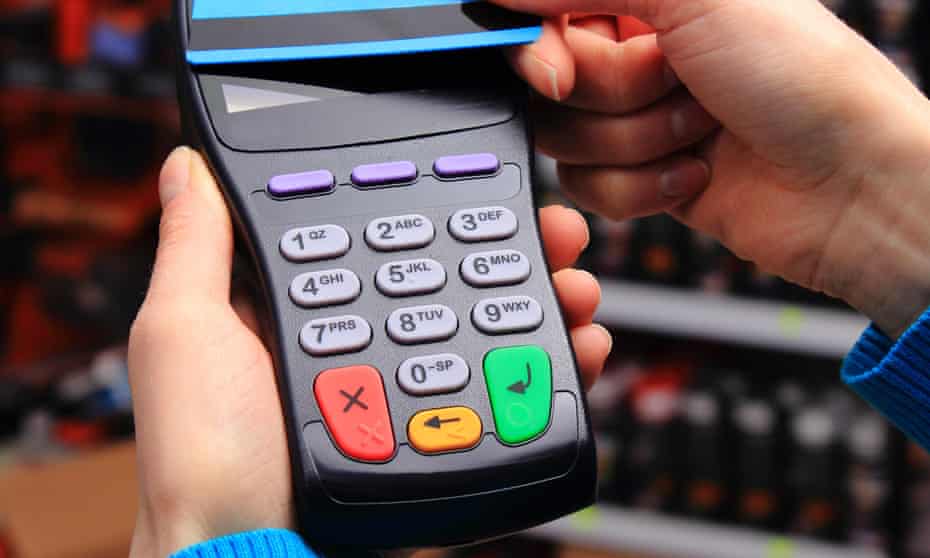 Hand of woman paying with contactless credit card with NFC technology