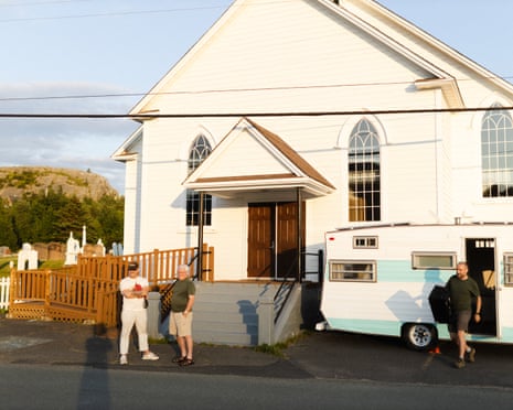 Men talk outside rural church