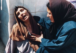 A woman cries outside the Zmirli Hospital, where the dead and wounded were taken after a massacre in Bentalha