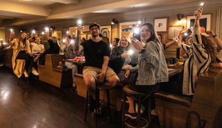 Patrons at a Breko’s Trivia event at the Clock Hotel in Surry Hills are asked to wave their phone lights at the bar.