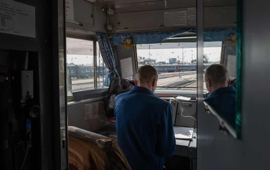 Train driver Gasyuk’s assistant is filling in the log on their stop in Lviv central station