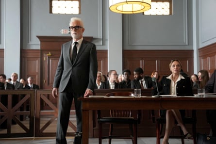 A besuited lawyer strides around the courtroom