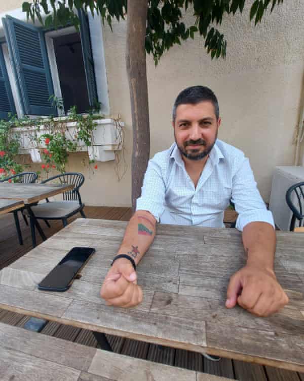 The journalist Ali Kismir whose right arm is tattooed with the work ‘peace’ in Greek and Turkish.