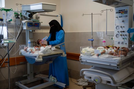A nurse prepares premature babies for transport to Egypt.