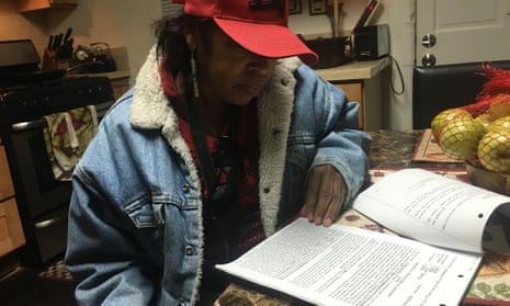 Leketha Williams, in her new home in Oakland, reviewing an old copy of her eviction lawsuit.
