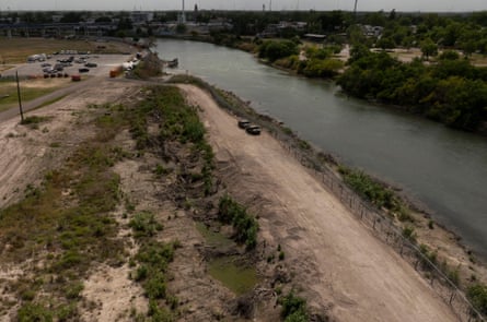 The US side of the border has been stripped of greenery, while the Mexican side is lush with vegetation.