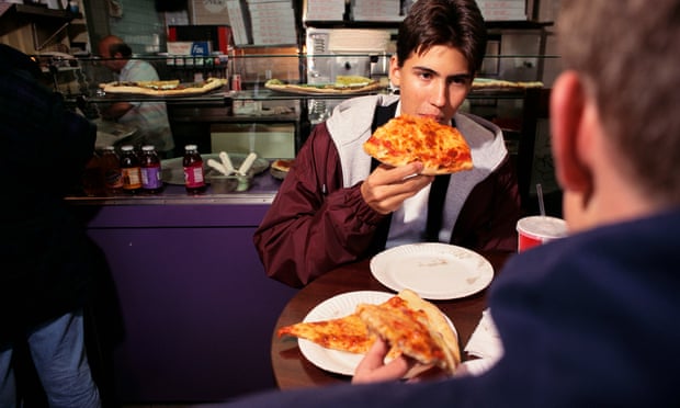 Customers eating pizza in Manhattan, New York