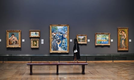 A woman walks through The National Gallery minutes before it closes until further notice, in London.