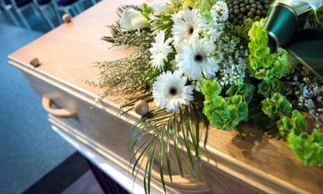 A coffin with a flower arrangement at a mortuary