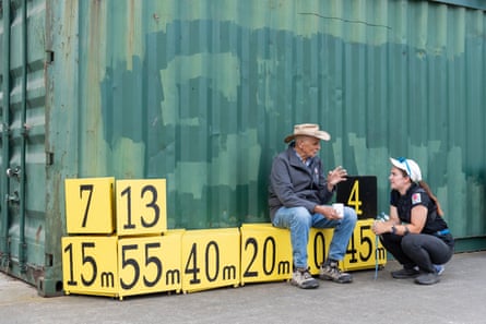 Dave Henshaw seated talks to a young competitor