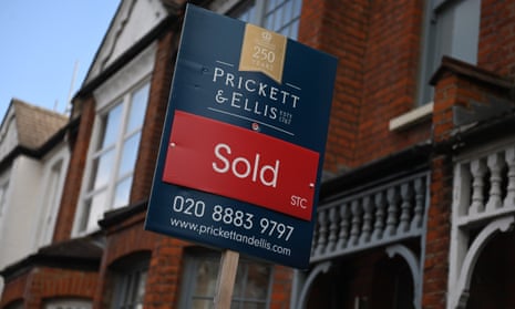 a sold sign next to a red brick victorian home