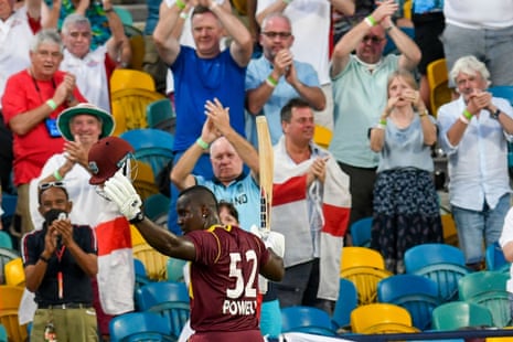 Rovman Powell of West Indies walks off the field as supporters of England cheer his century.