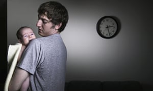 Father holding crying baby in middle of the night