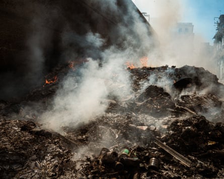 Smoke rises from a pile of burning rubbish