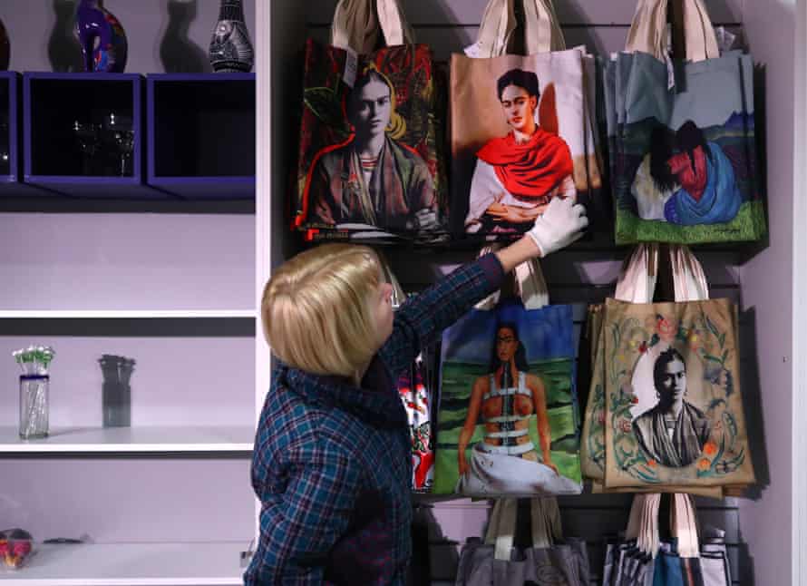 A woman browses a souvenir store full of Frida Kahlo-print tote bags at a Kahlo exhibition in Russia.
