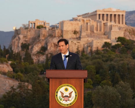 Man at lectern in front of citadel