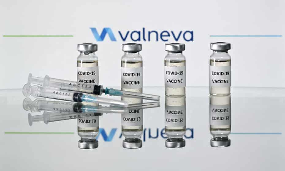 Vials marked 'Covid vaccine' with Valneva logo in background.
