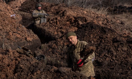 A Ukrainian service member digging a trench outside Bakhmut on Saturday