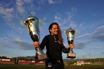 Azra Numanovic holding up two trophies