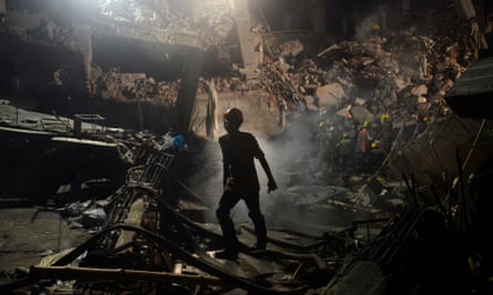 A Bangladeshi worker leaves the site where a garment factory building collapsed near Dhaka, Bangladesh in April 2013.