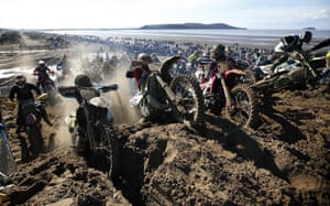 Riders attempt to reach the summit of a dune