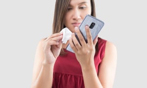 Woman wiping mobile phone