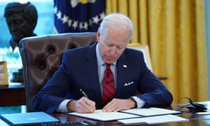 Joe Biden signs executive orders on health care in the White House in Washington DC on 28 January 2021