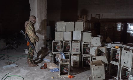 A rebel soldier stands in the basement of a Captagon factory