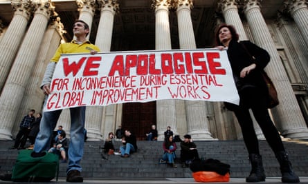 Protesters hold up a banner at the Occupy London Stock Exchange protest camp on the steps of St Paul’s Cathedral, London, November 2011.