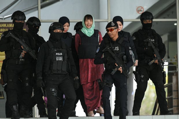 Doan Thi Huong is escorted by Malaysian police out of the high court in Shah Alam on 1 April.
