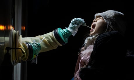 A health worker takes a swab sample from a woman to test for the Covid-19 coronavirus.