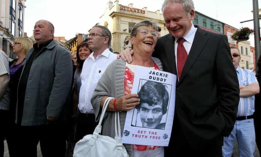 A relative of Bloody Sunday victim Jackie Duddy with Martin McGuinness on the way to gain a preview of the Saville Report in 2010 in Derry.