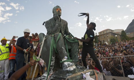 The defaced statue of British mining magnate and politician Cecil John Rhodes as it is removed from its position at the University of Cape Town.