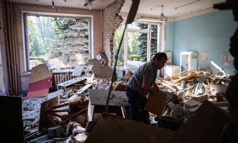A man searches for surviving items in a school destroyed by a missile strike in the town of Kramatorsk, in Donetsk region, on August 19, 202. (Photo by ANATOLII STEPANOV / AFP) (Photo by ANATOLII STEPANOV/AFP via Getty Images)