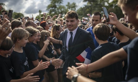 Antoine Dupont surrounded by fans as he arrives at the Parc du Bois-Préau in Rueil-Malamaison, near Paris