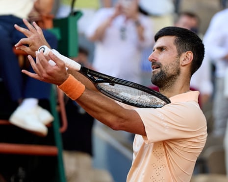 Novak Djokovic mimics a violin with his racket.