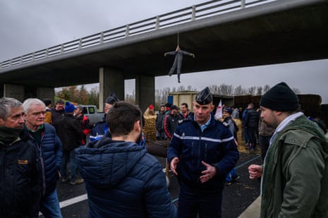 Farmers block a highway and speak with military police near Villefranche-de-L'Araguey on the outskirts of Toulouse to protest against reduced taxes and income.