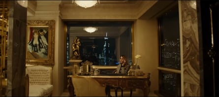 A woman sits in a lavish apartment taking a phone call