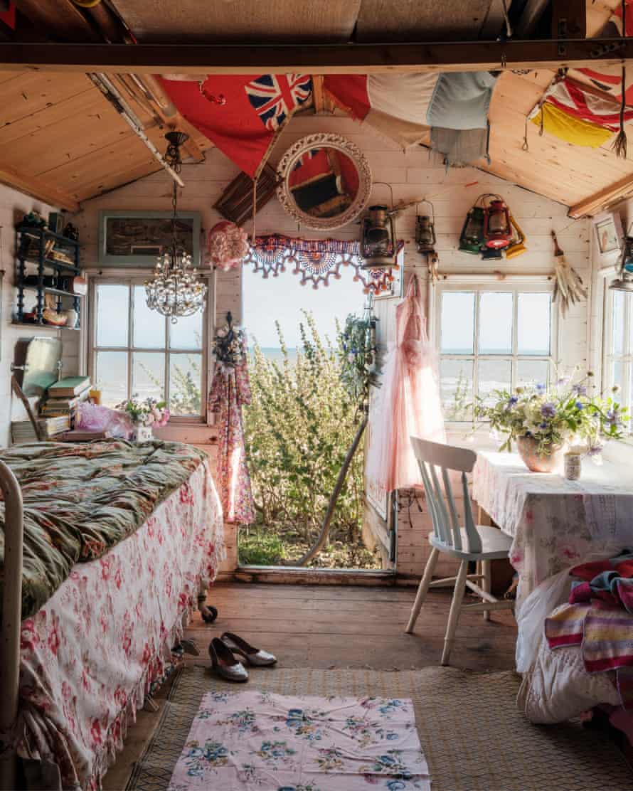 Play house: inside the retro hut, which has old flags suspended from the roof. The bed is from an old hospital.