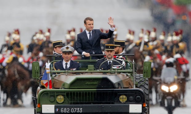 Macron rides in a military vehicle on the Champs Élysées after his inauguration on 14 May.